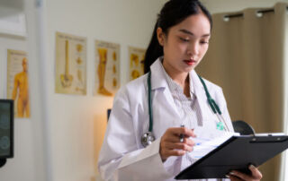healthcare professional reviewing patient information during hands-on healthcare career training at Hawaii Medical College