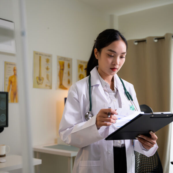 healthcare professional reviewing patient information during hands-on healthcare career training at Hawaii Medical College