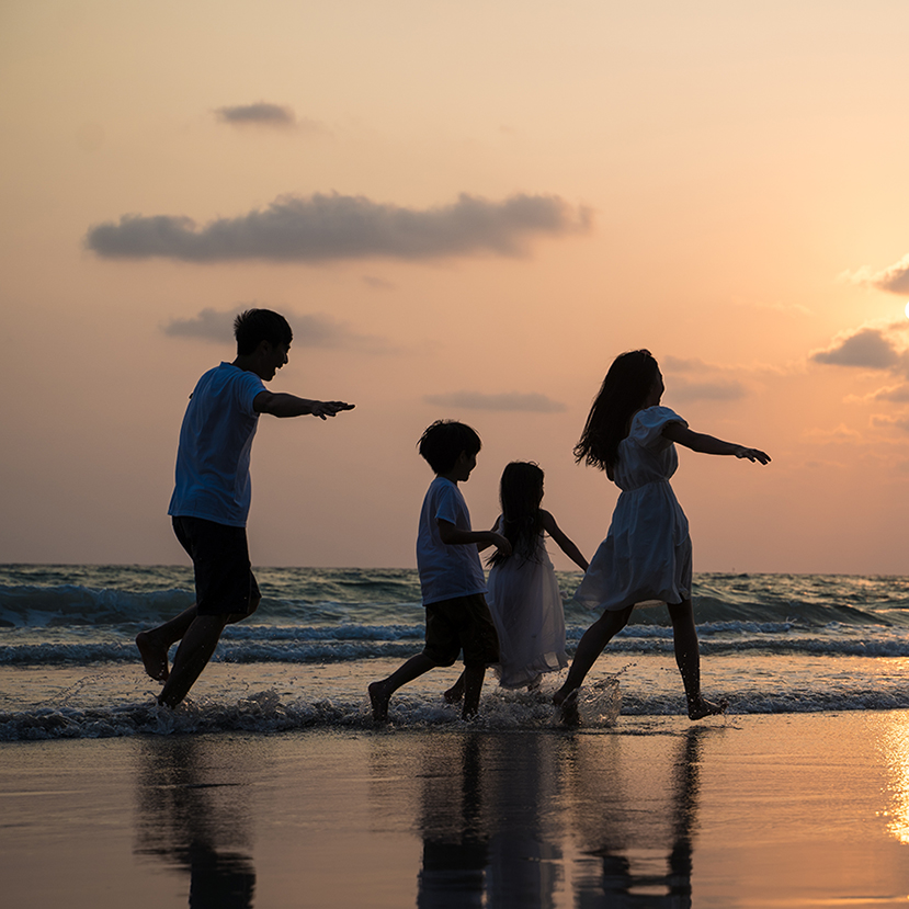 Family walking and playing at beach sunset with kids happy vacation concept