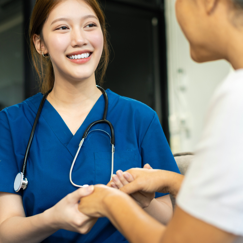 Female doctors shake hands with patients encouraging each other.