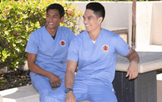 Hawaii Medical College students in scrubs smiling outdoors, representing future healthcare professionals starting careers with a diploma.