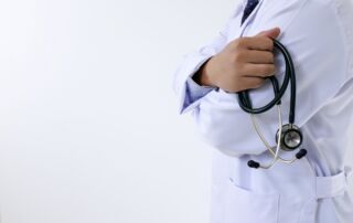 doctor holding stethoscope representing AI-proof healthcare careers and future medical job training at Hawaii Medical College