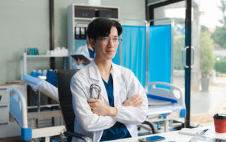 Healthcare student in clinical training wearing a white lab coat and stethoscope at Hawaii Medical College