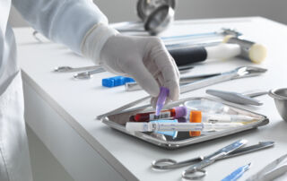Clinical Medical Assistant preparing blood collection tubes and medical instruments during clinical training.